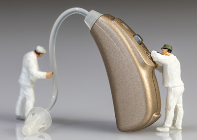 Audiologists doing hearing aid maintenance